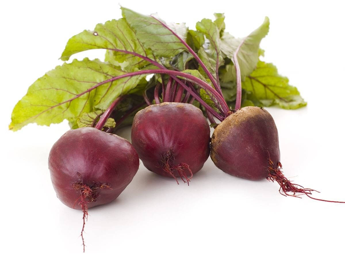 Fresh Red Beetroots With Green Leaves Background