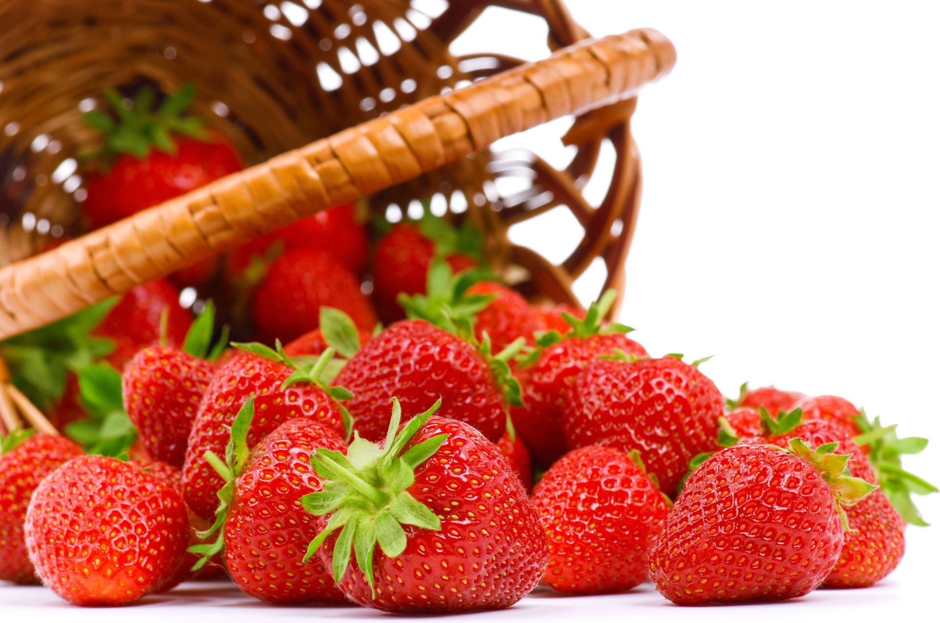 Fresh Strawberries Tumbling From A Wicker Basket Background