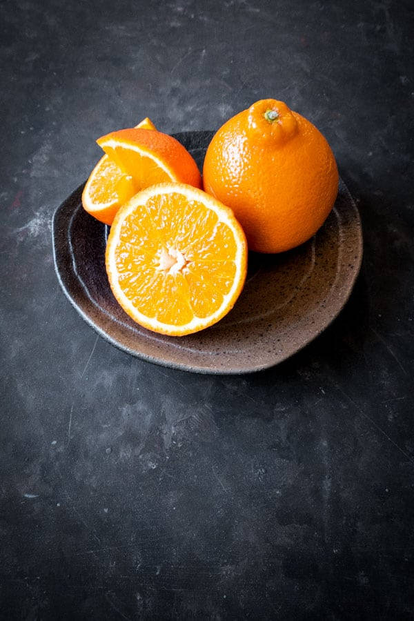 Fresh Tangelo Fruits In A Saucer Background