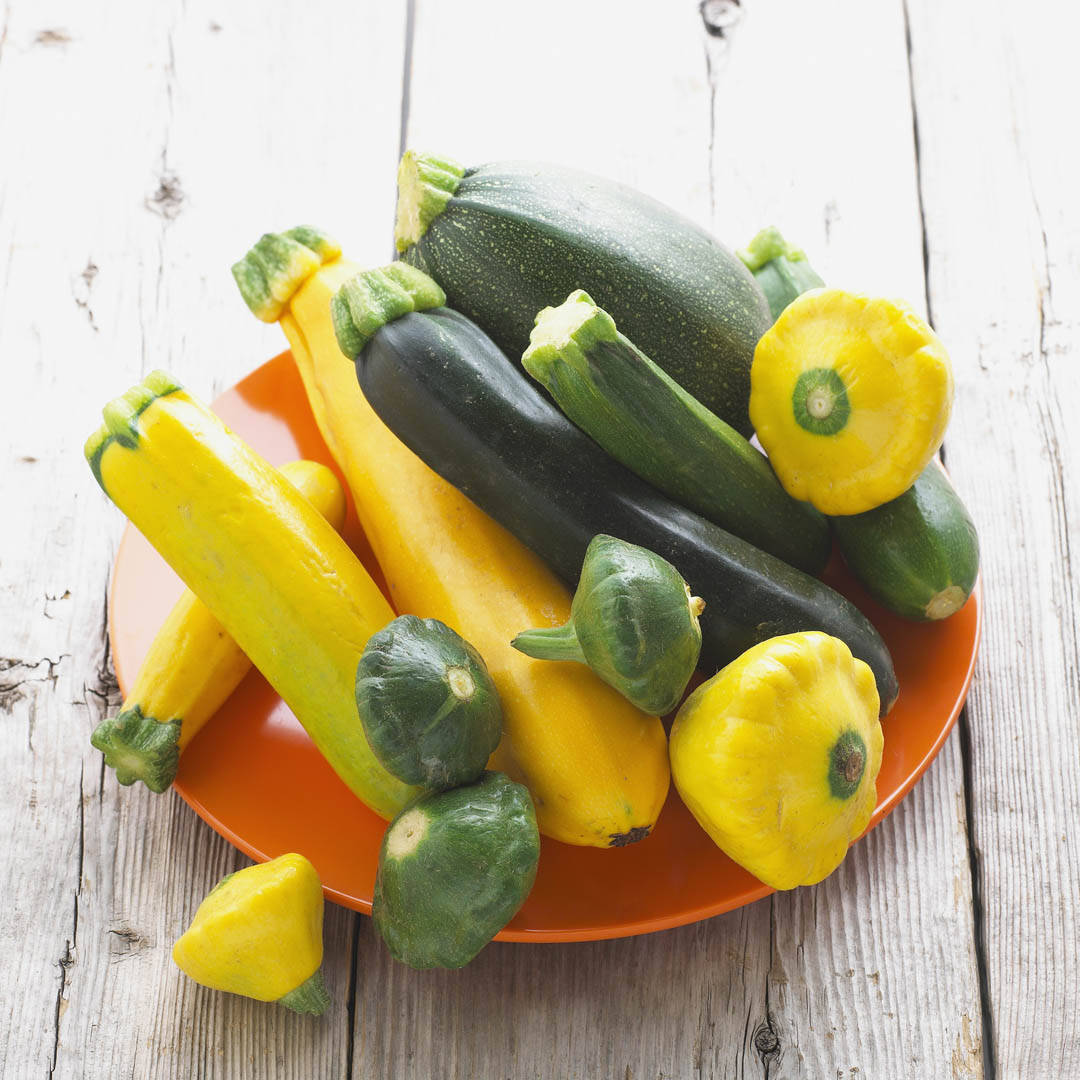 Fresh Yellow Squash And Zucchini On Plate Background