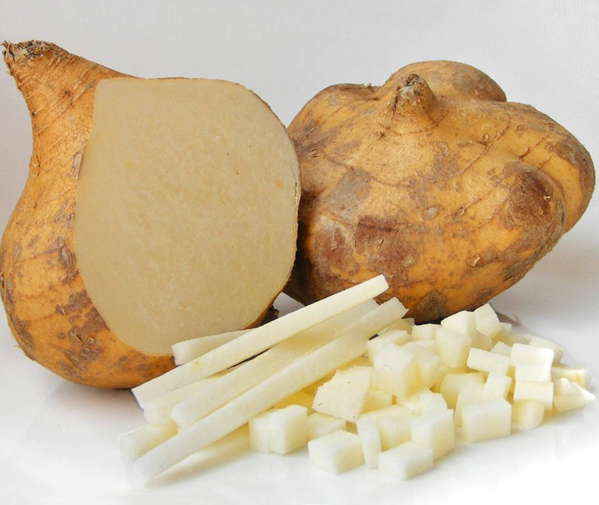 Freshly Prepared Jicama, Cut Into Strips And Mini Cubes Background