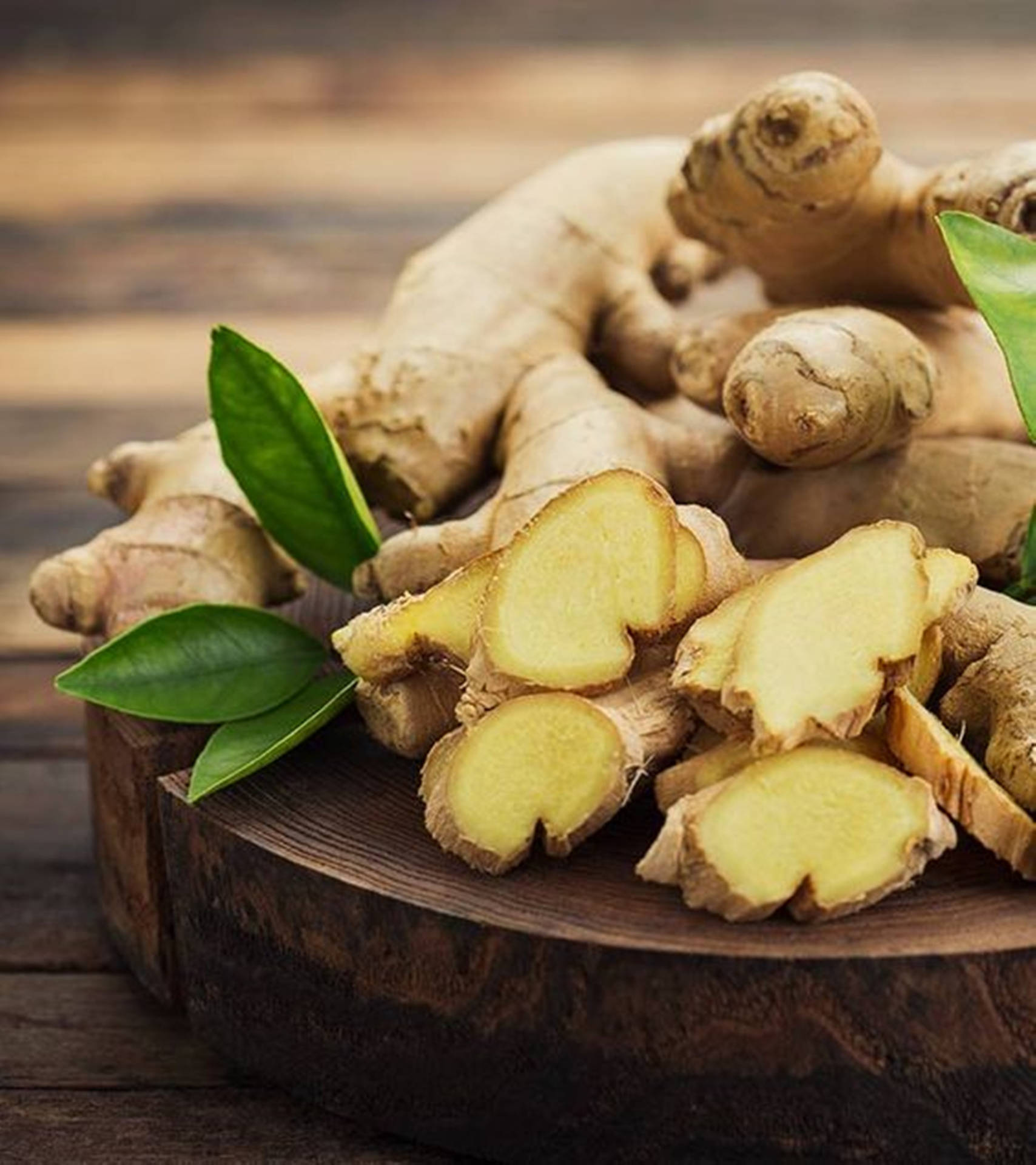 Freshly Sliced Ginger Rhizomes On Chopping Board Background