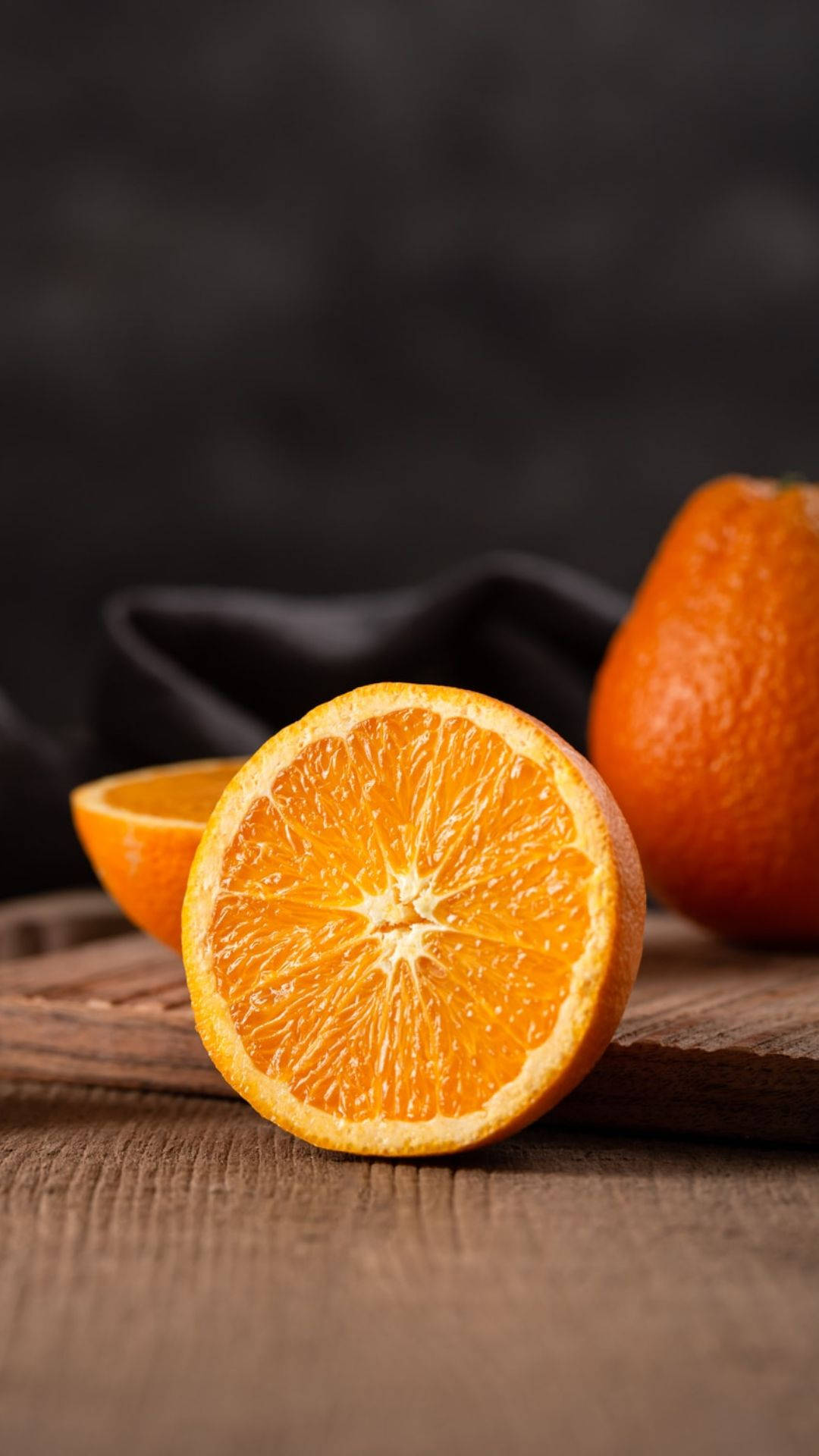 Freshly Sliced Orange On A Wooden Surface Background