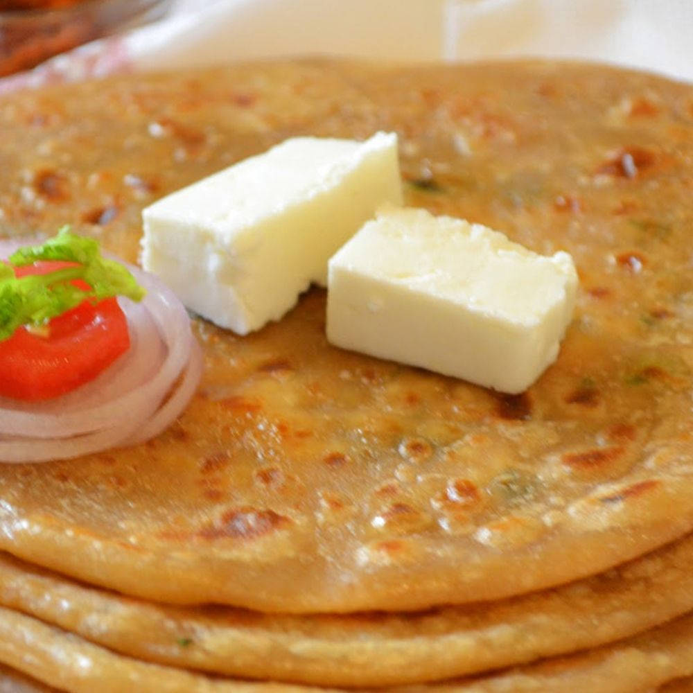 Freshly Spread Butter On Onion And Tomato Flatbread Background