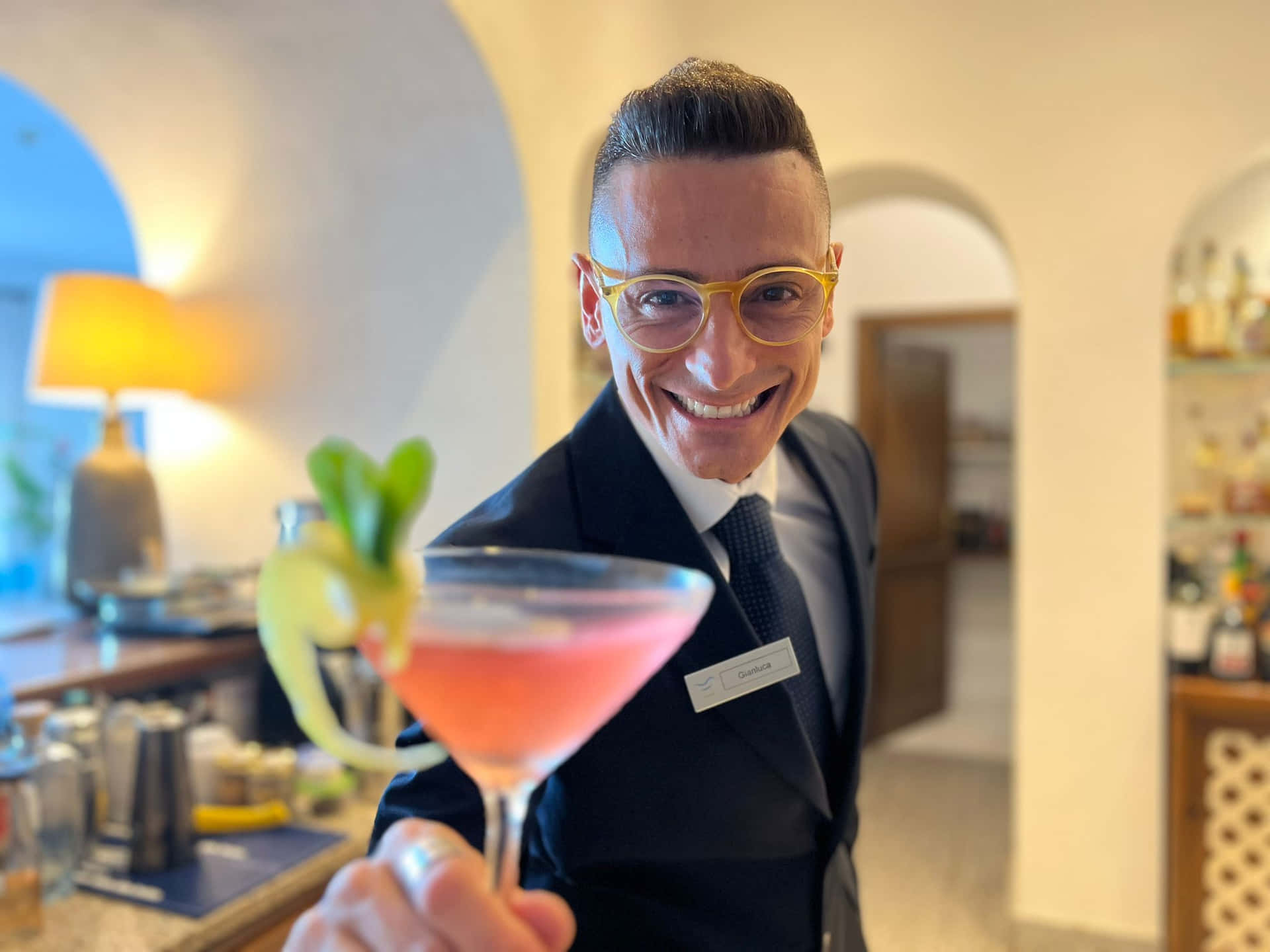 Friendly Bartender Offering Cocktail