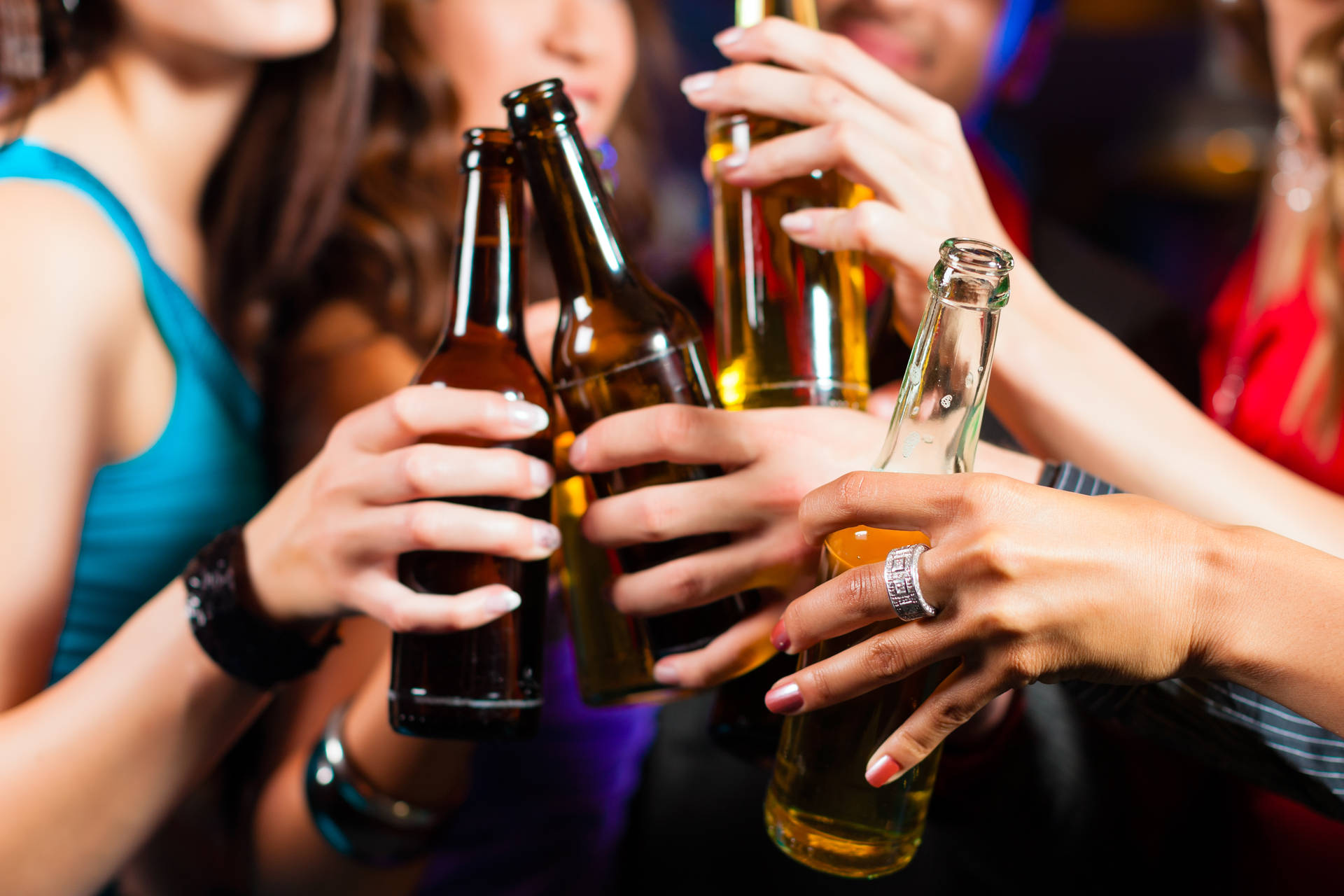 Friends Toasting With Chilled Beer Bottles