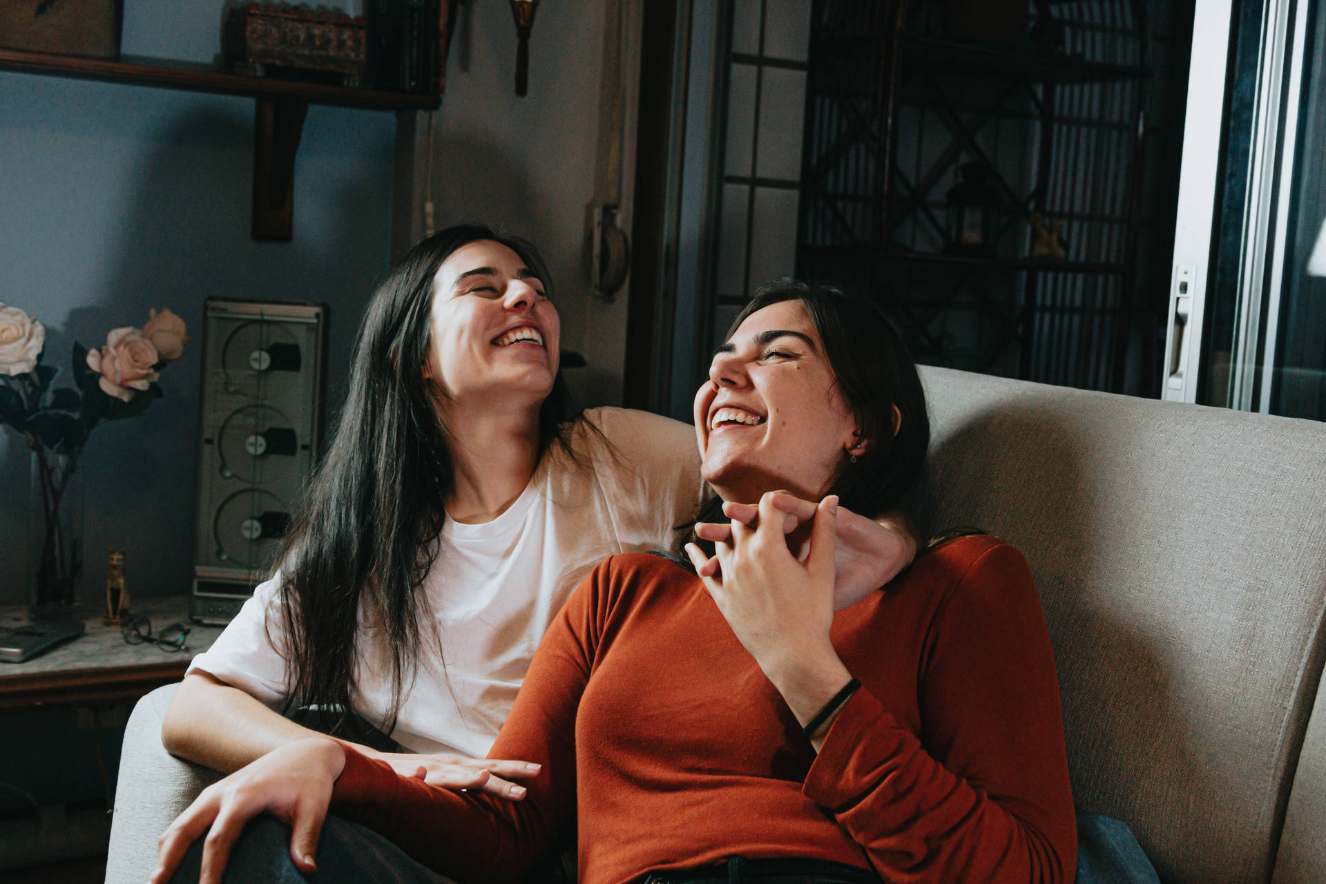 Friendship Of Two Women On Couch Background