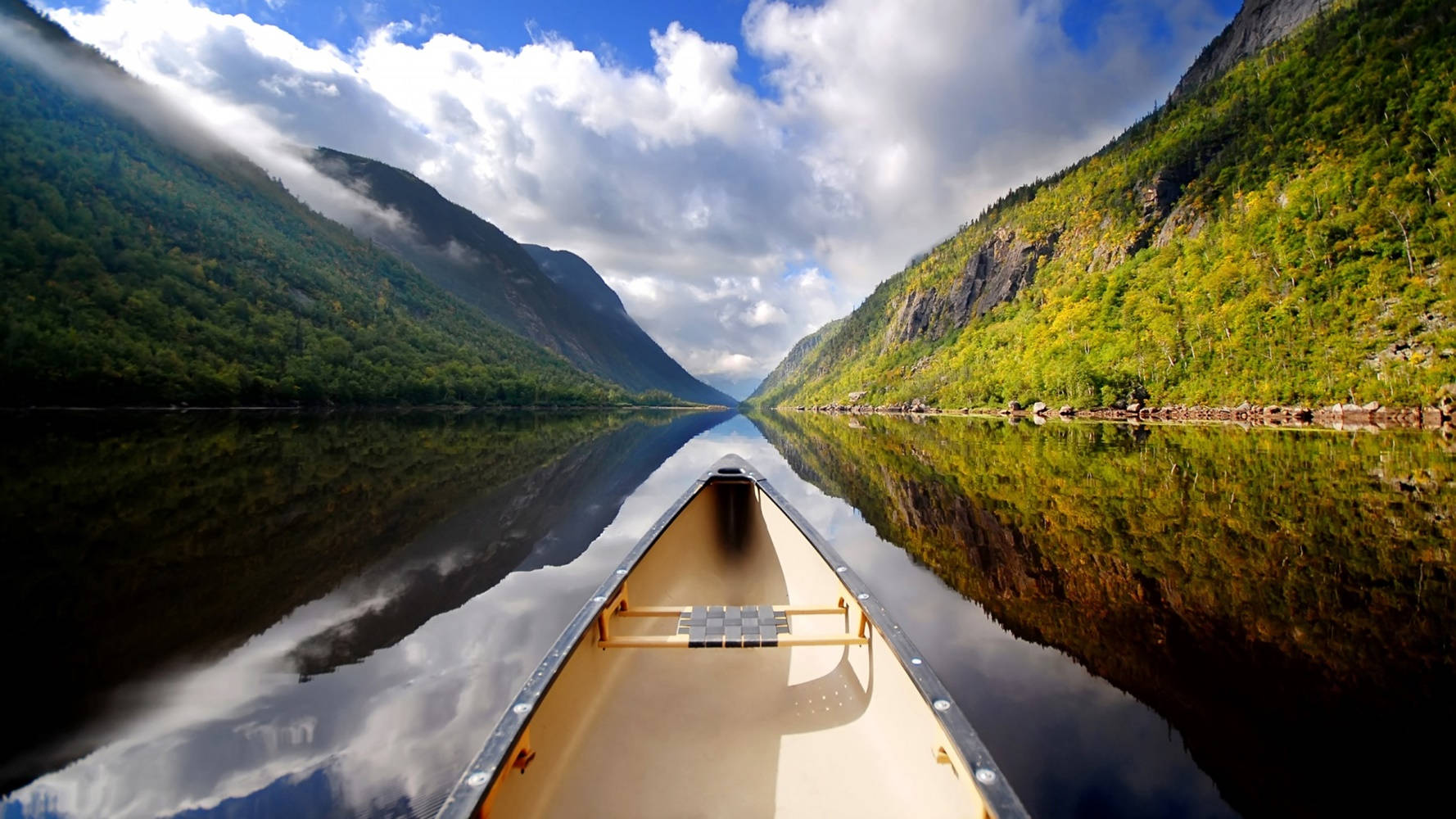 Front View Of Two People Canoeing On Calm Waters