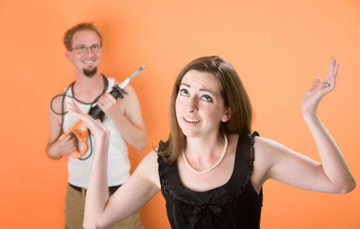 Frustrated Woman And A Man With Reciprocal Saw Against An Orange Background Background