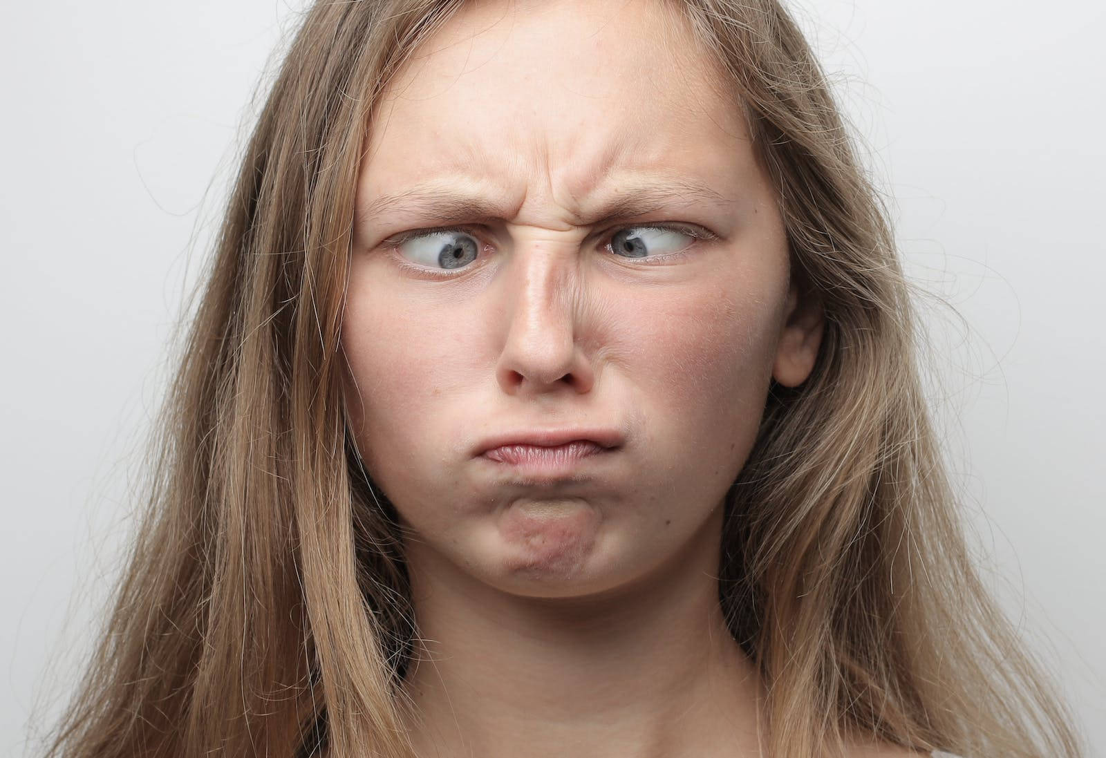 Furious Young Woman With Scrunched Nose Background