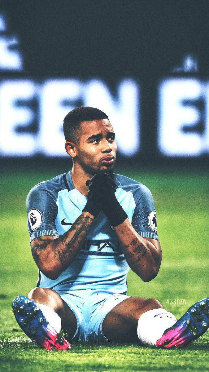 Gabriel Jesus Sits Down Hands Together Background