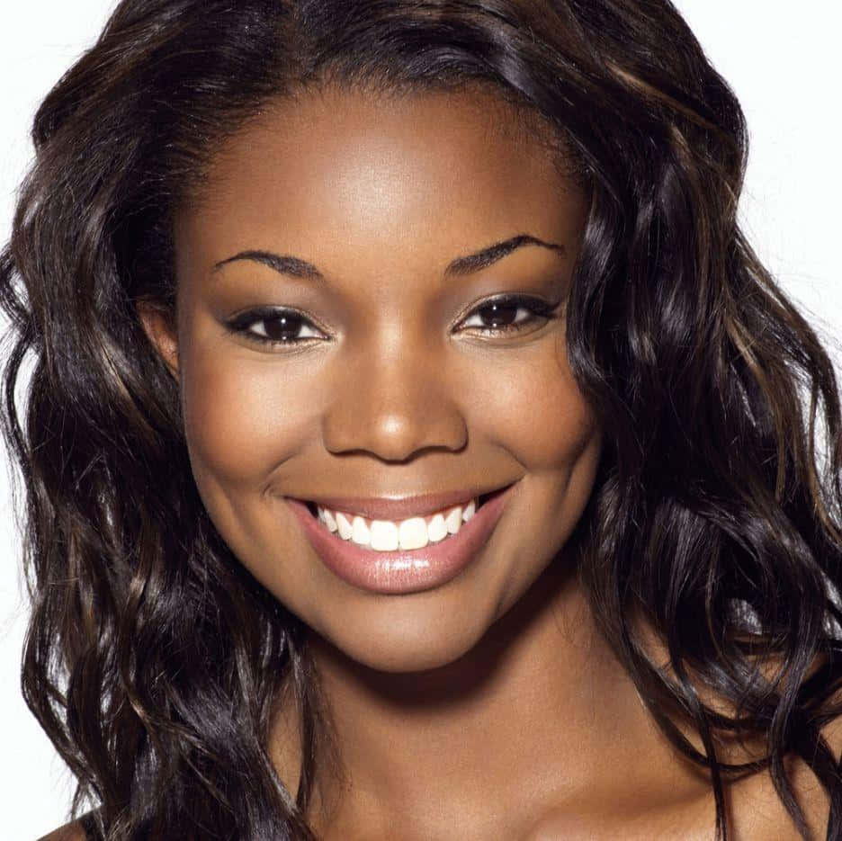 Gabrielle Union Smiling Radiantly In A Black Off-shoulder Outfit Background