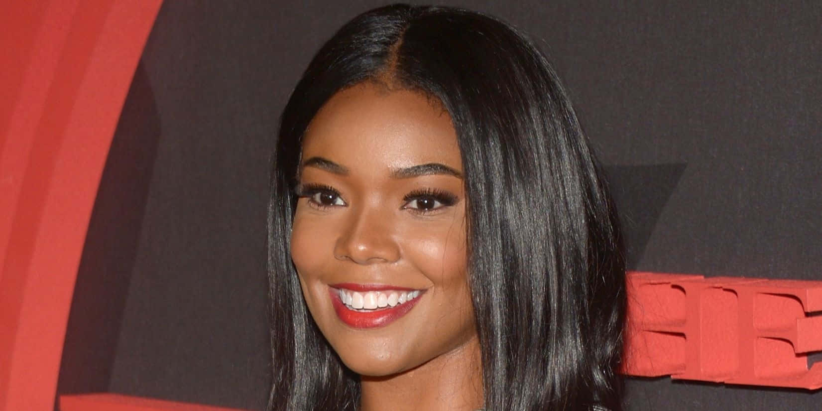 Gabrielle Union Smiling Radiantly In White Outfit Background