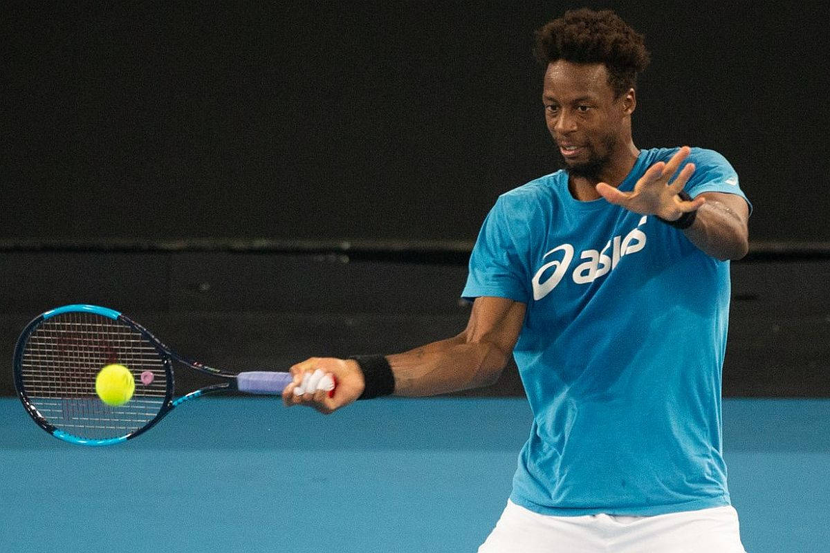 Gael Monfils In Action On Tennis Court Background