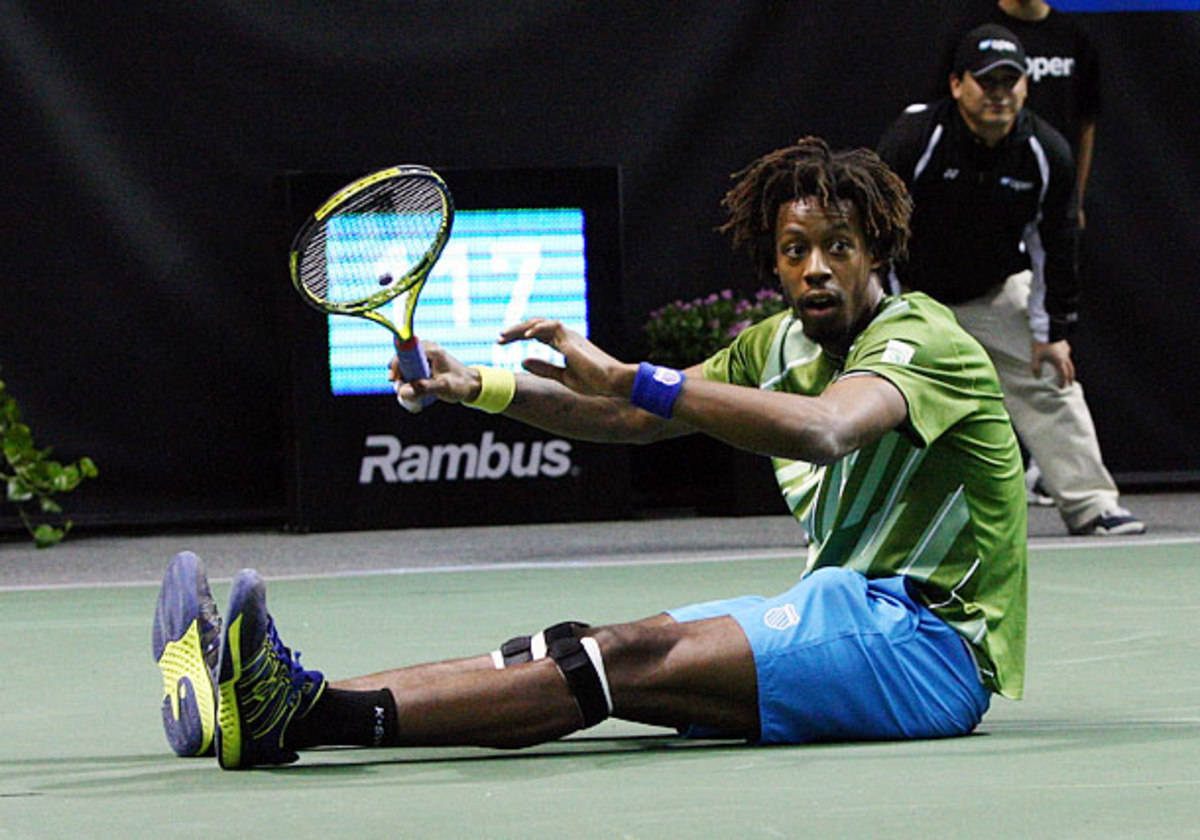 Gael Monfils Sitting On Tennis Court Background