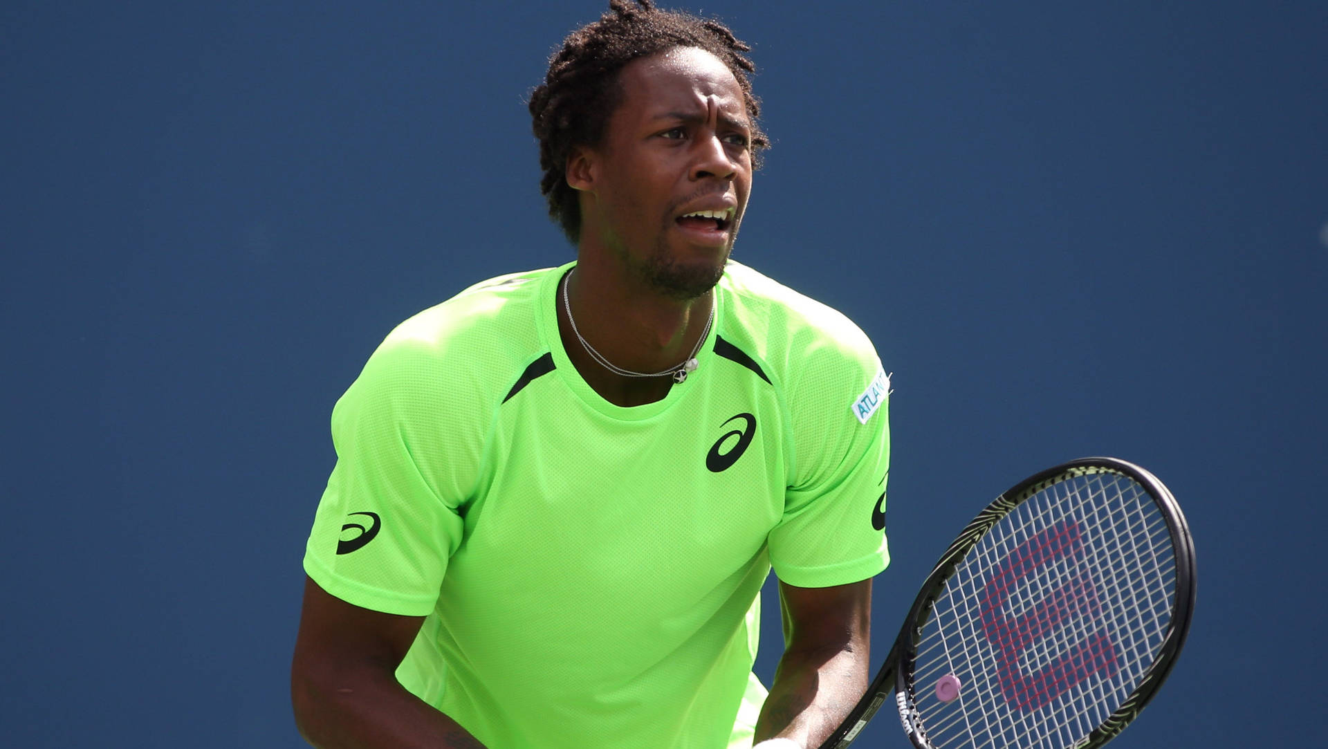 Gael Monfils Wearing Bright Neon Shirt Background