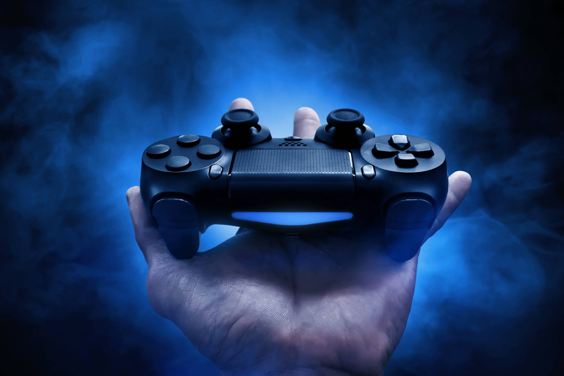 Gaming Controller On Hand Background