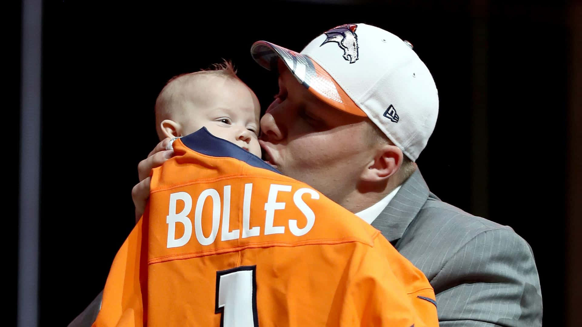 Garett Bolles Kissing His Son Background