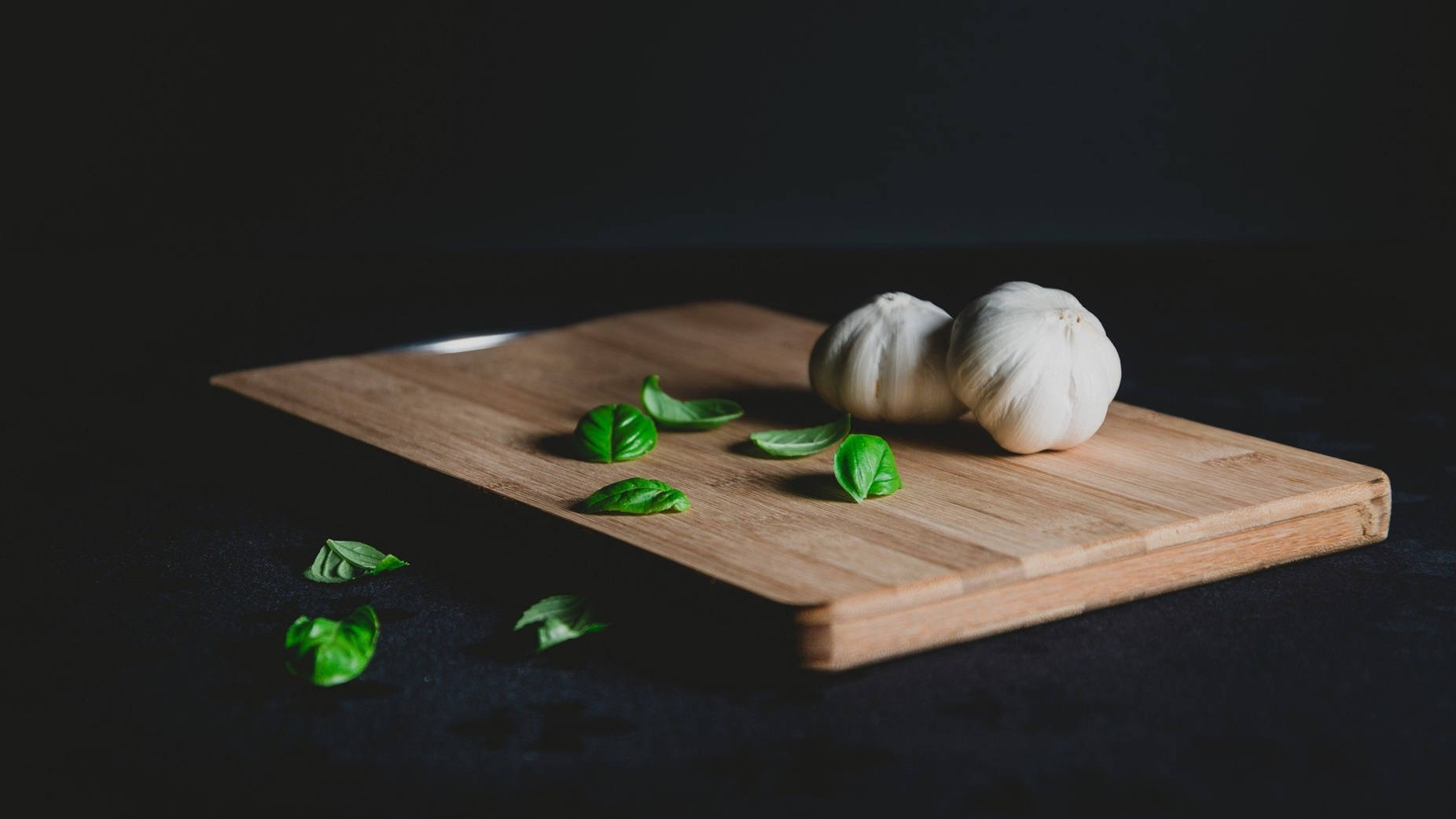 Garlic Vegetable Herb With Leaves On Chopping Board Background