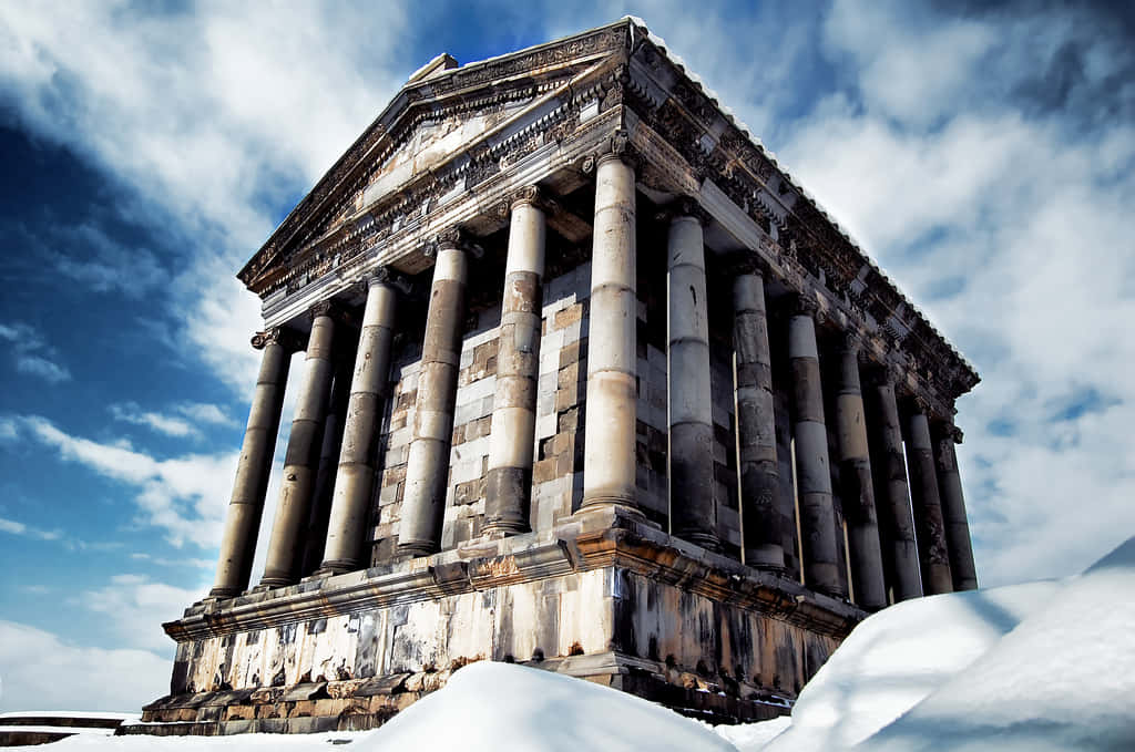 Garni Temple With Blue Sky And Clouds Background