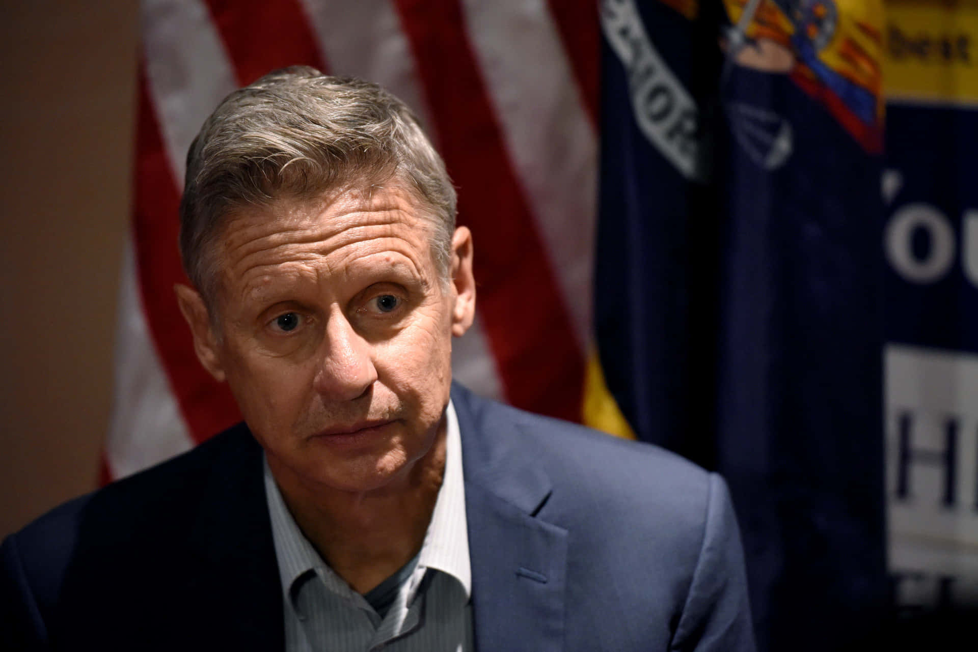 Gary Johnson In Dark Blue With Us Flag Background