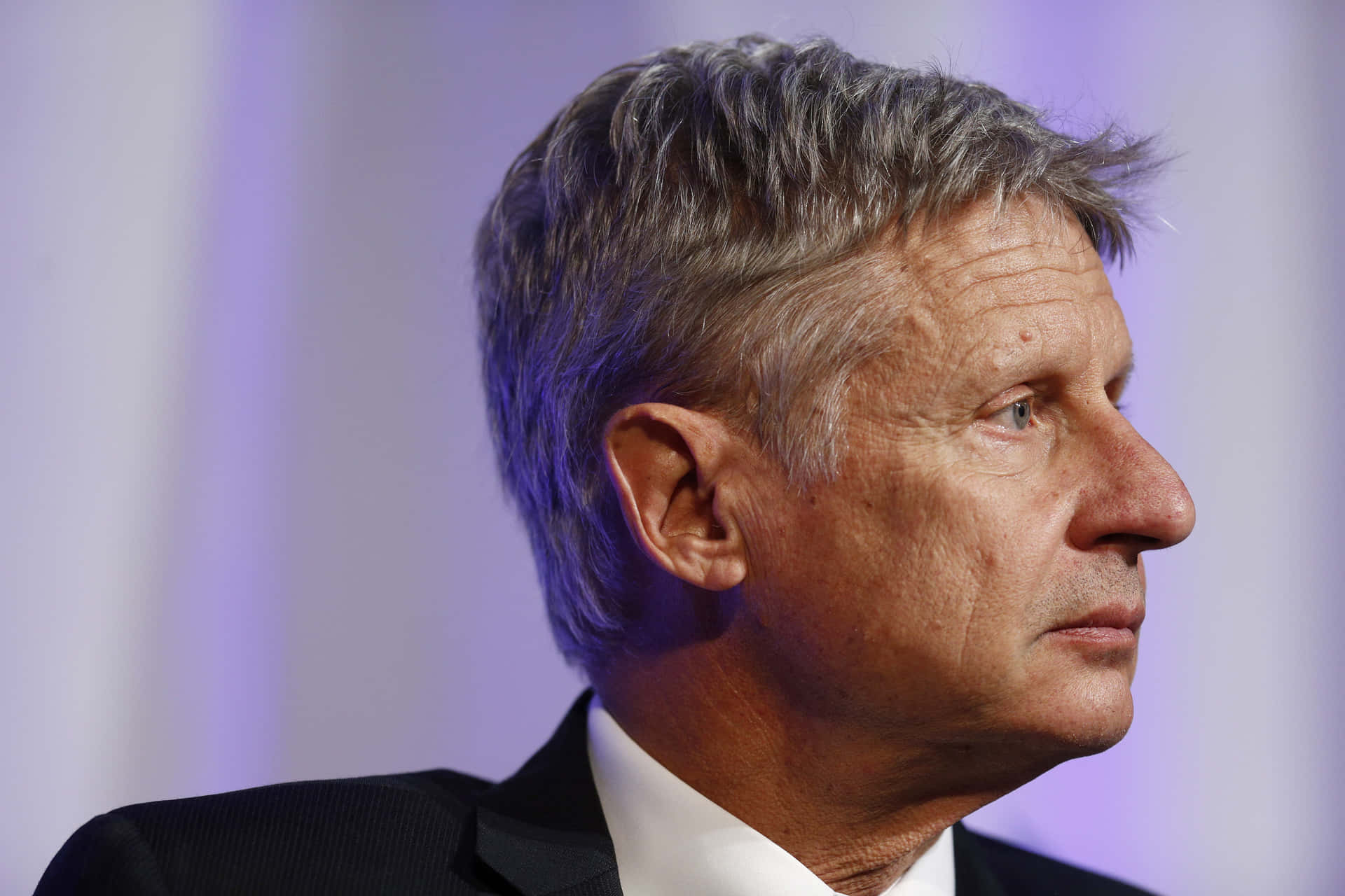 Gary Johnson Looking Sideways With A Purple Backdrop Background