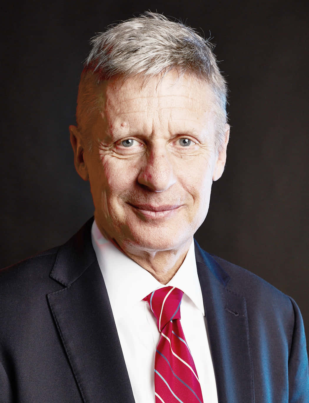 Gary Johnson Outfitted In A Black Suit Background
