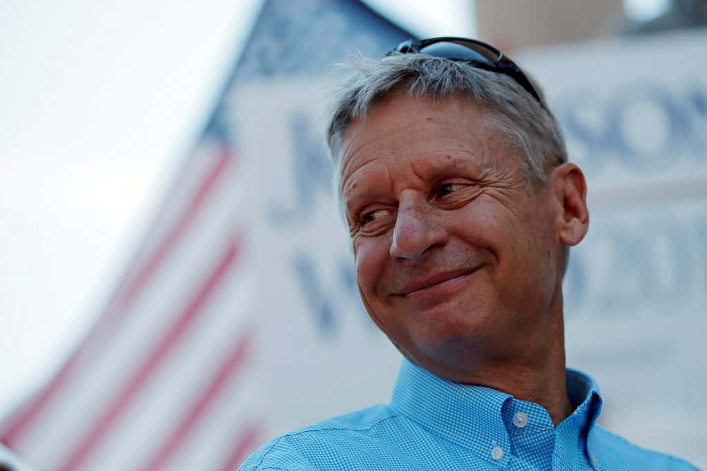 Gary Johnson Smiling In A Blue Shirt Background