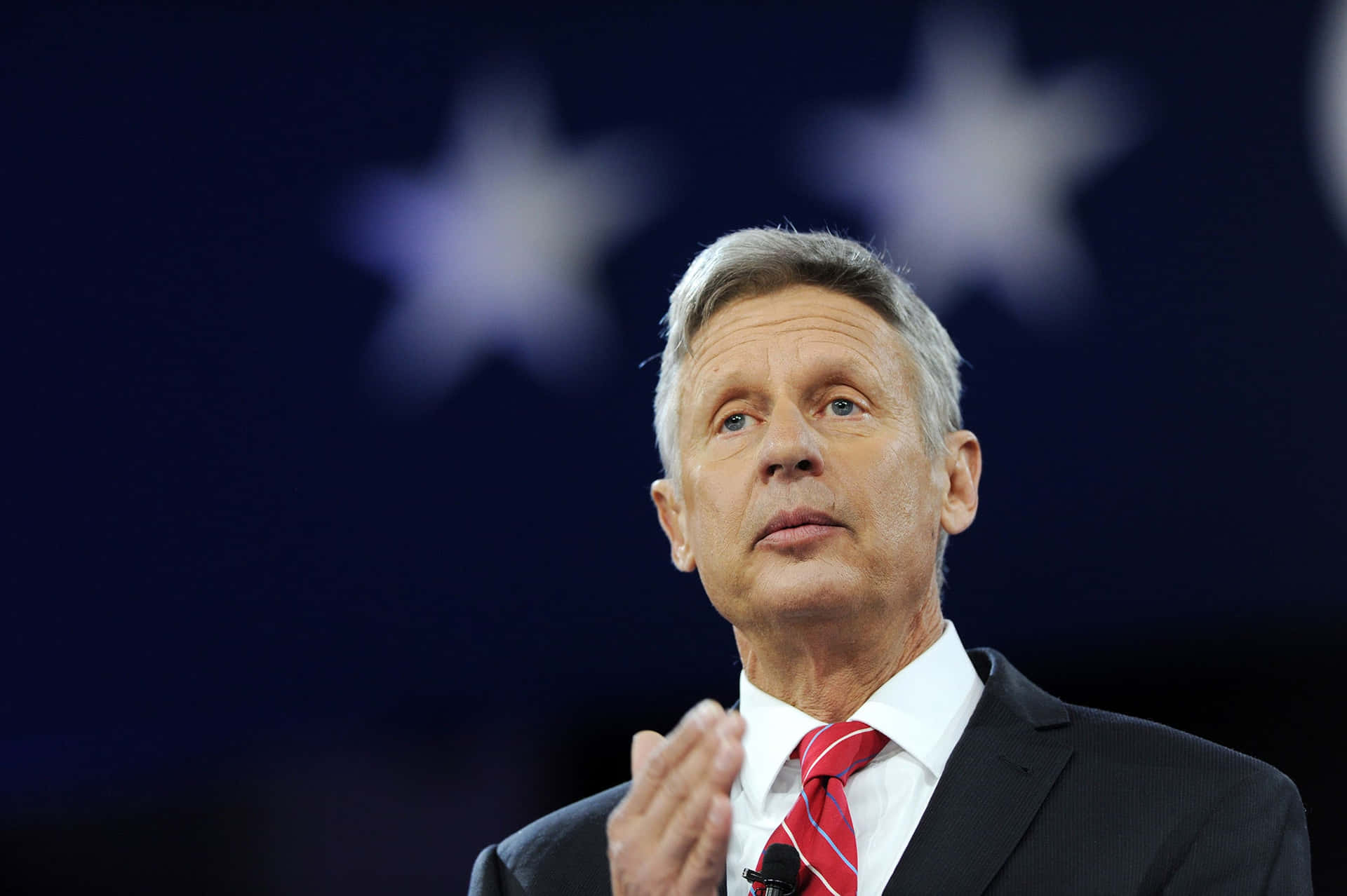 Gary Johnson With A Starry Dark Blue Backdrop Background