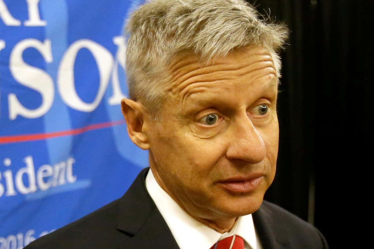 Gary Johnson With Black And Blue Backdrop Background