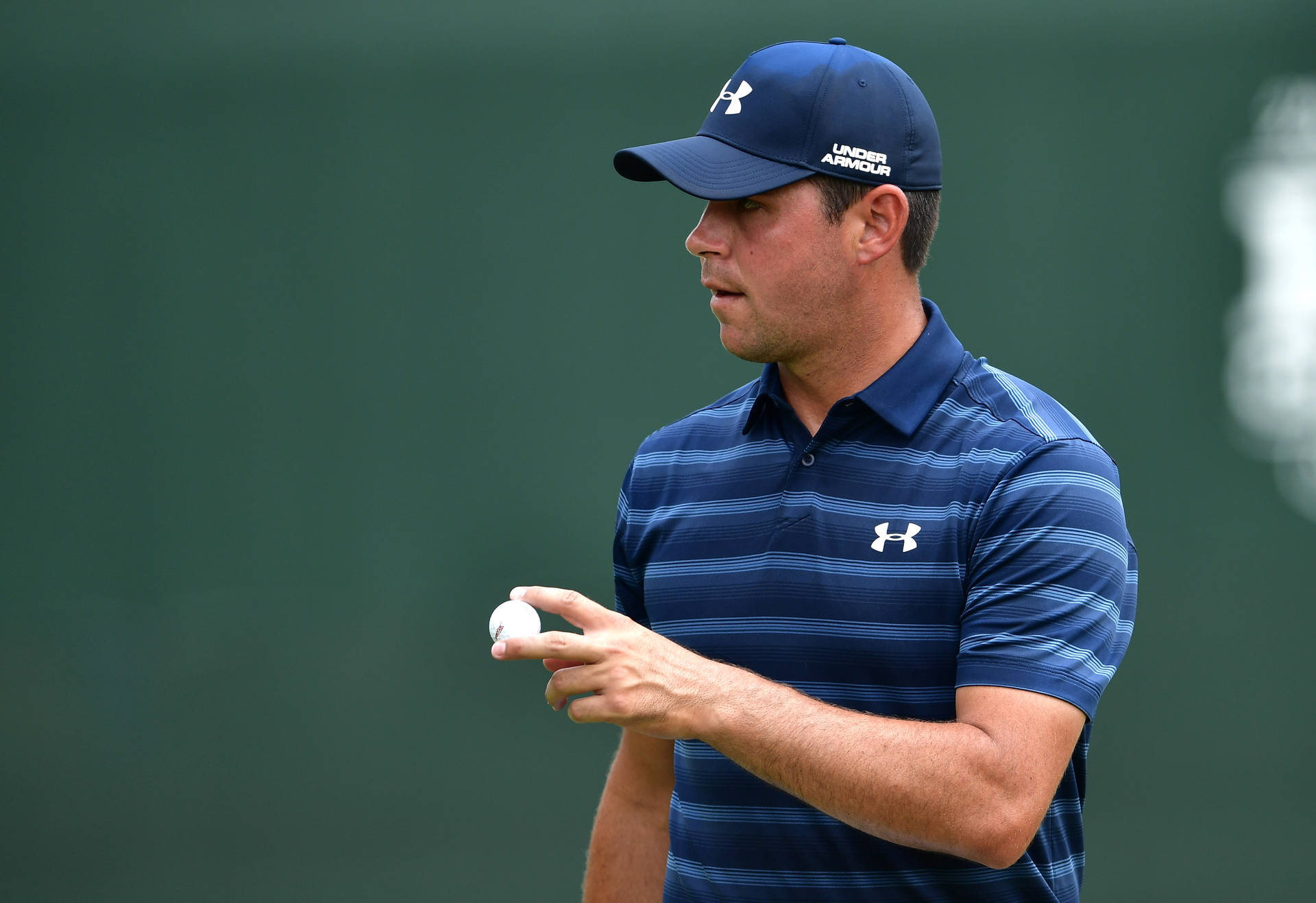 Gary Woodland Proudly Holding A Golf Ball During A Tournament Background