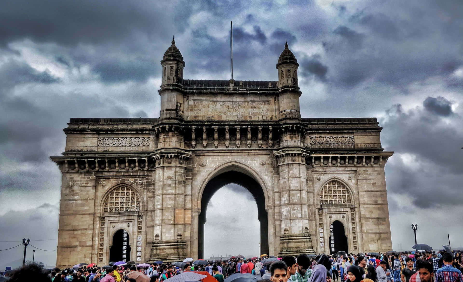 Gateway To India Crowds Gray Sky Background