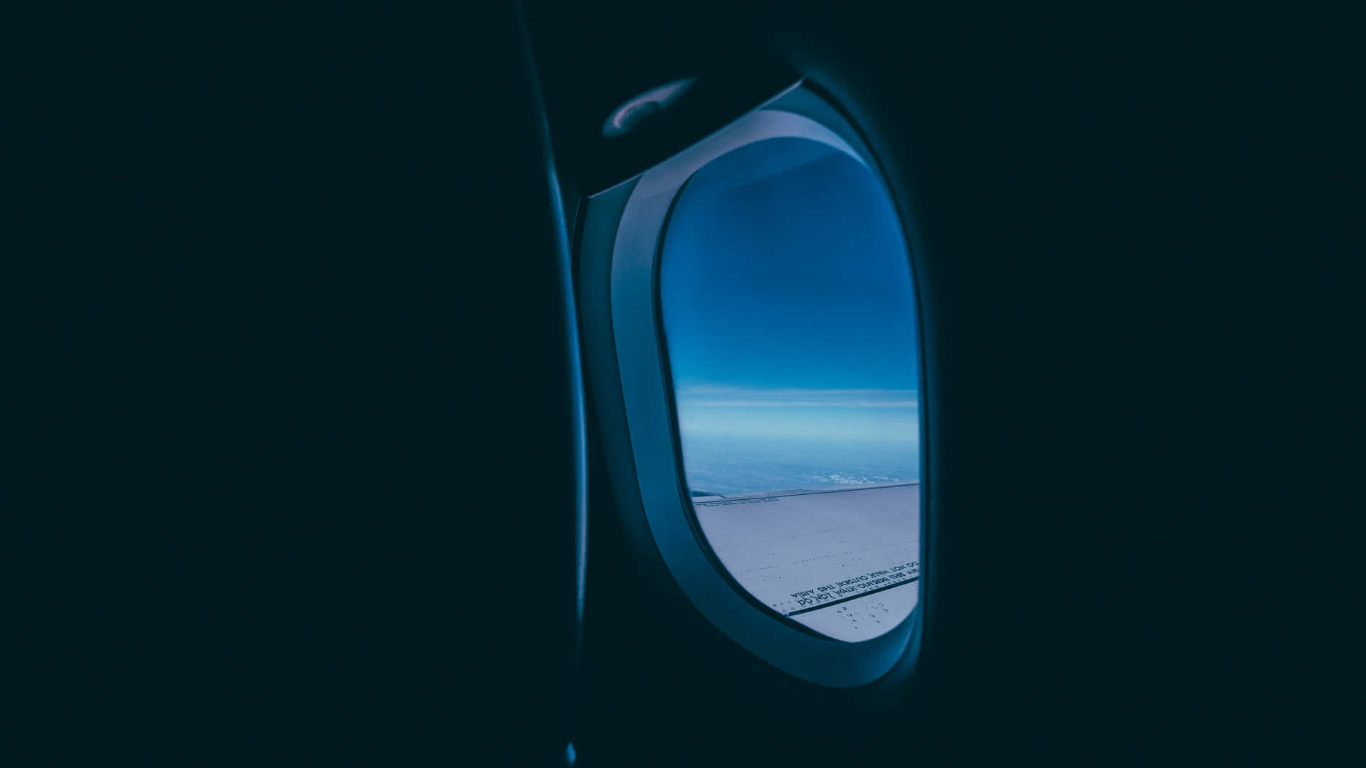 Gazing At The Blue Sky Through An Airplane Window