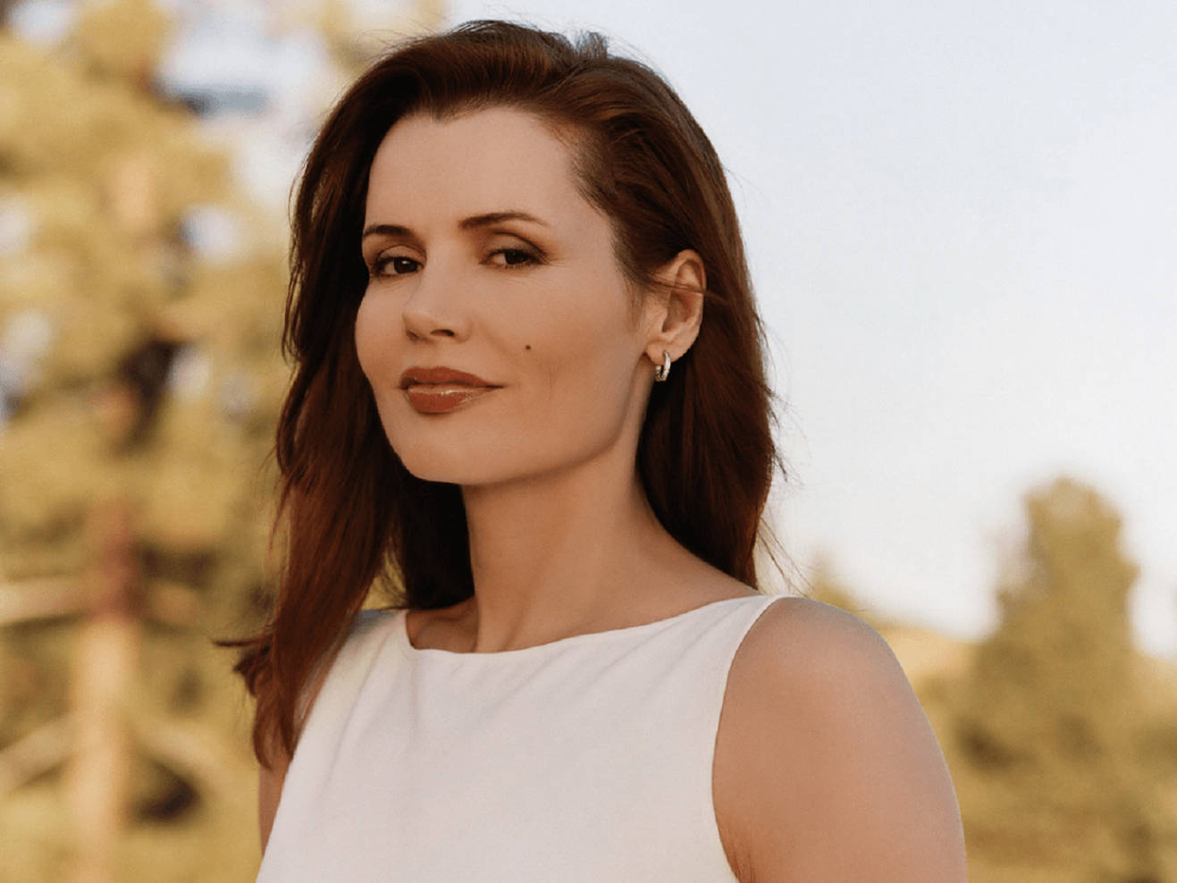 Geena Davis In A White Dress Background