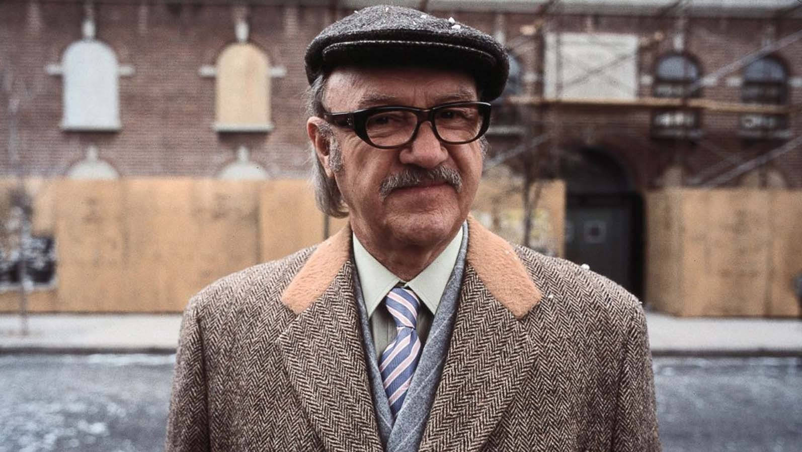 Gene Hackman In Newsie Cap Background