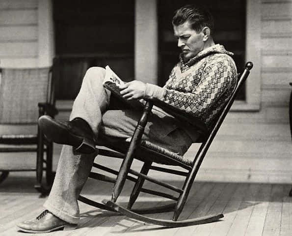 Gene Tunney Sitting On A Rocking Chair Background