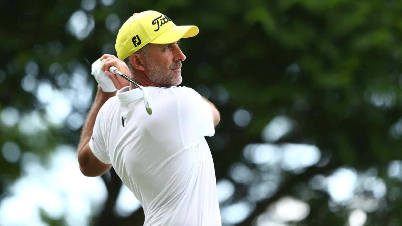 Geoff Ogilvy In Yellow Cap Background