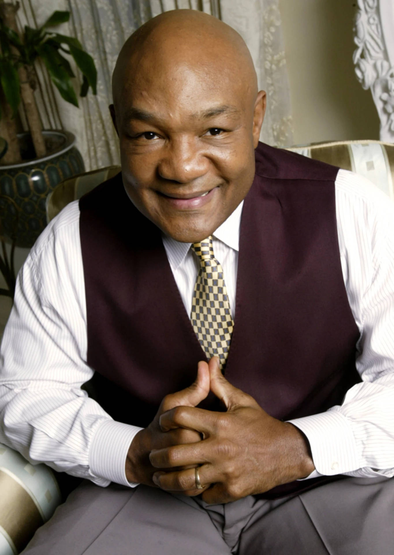 George Foreman, Former World Heavyweight Champion, In A Vest Background