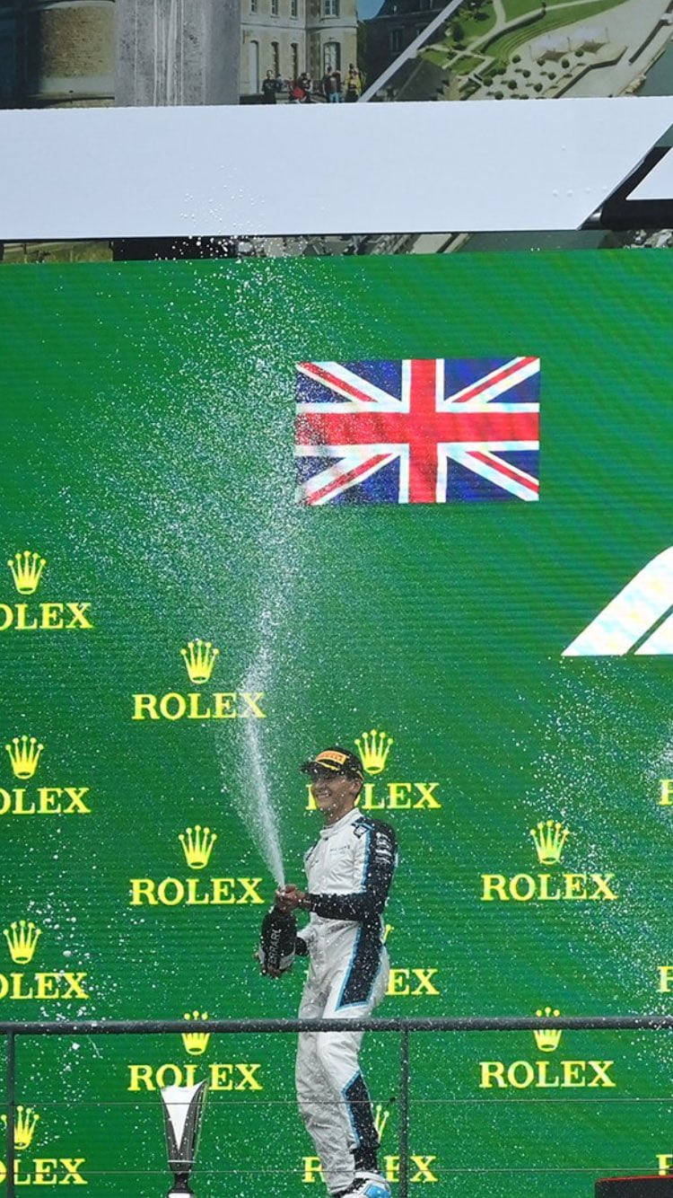 George Russel Popping A Bottle Background