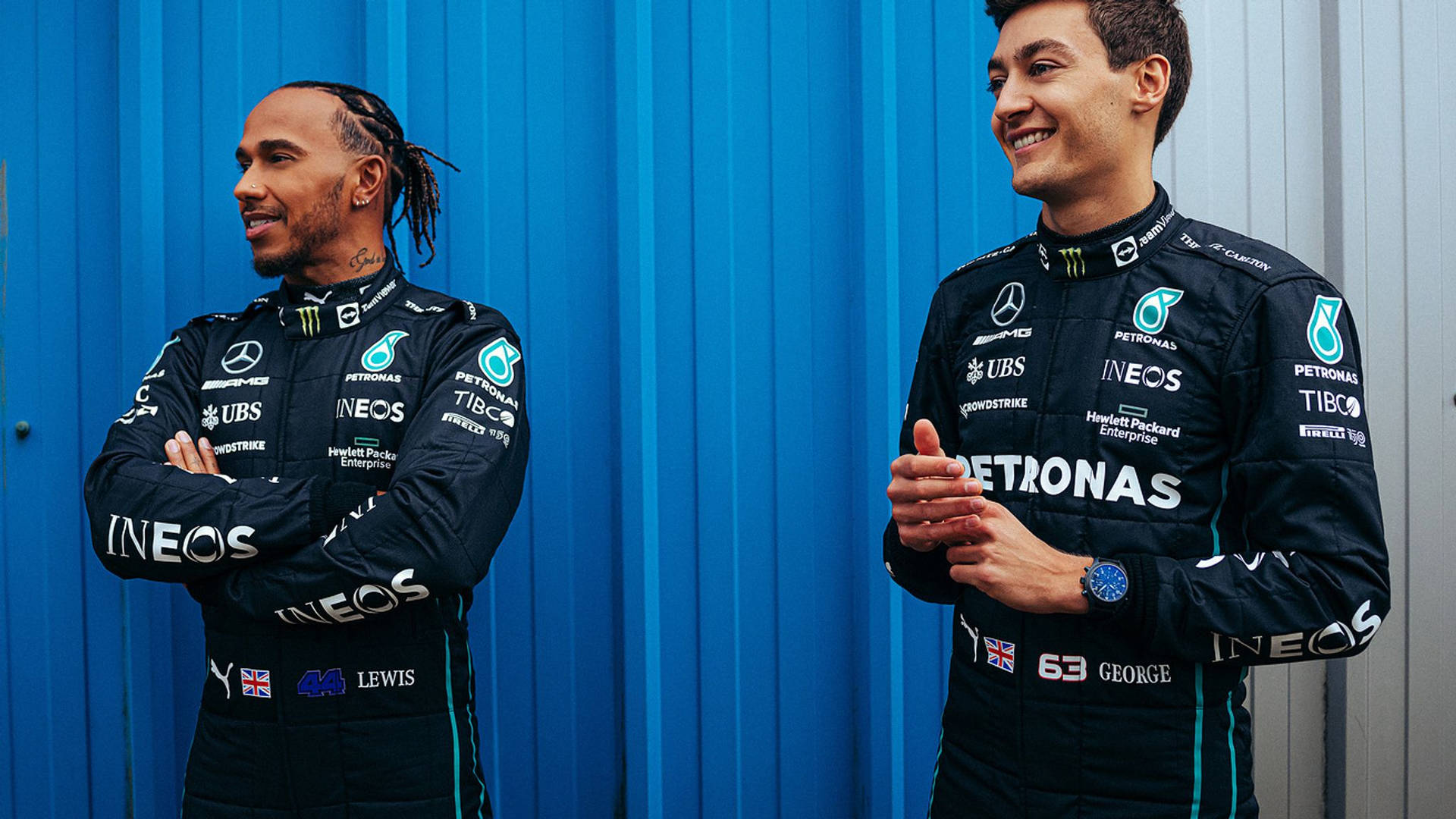 George Russell And Lewis Hamilton Sharing A Moment Of Joy On The F1 Track