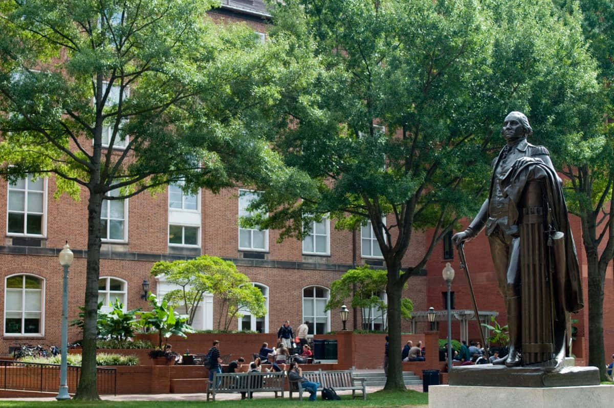 George Washington University Statue Surrounded By Trees Background