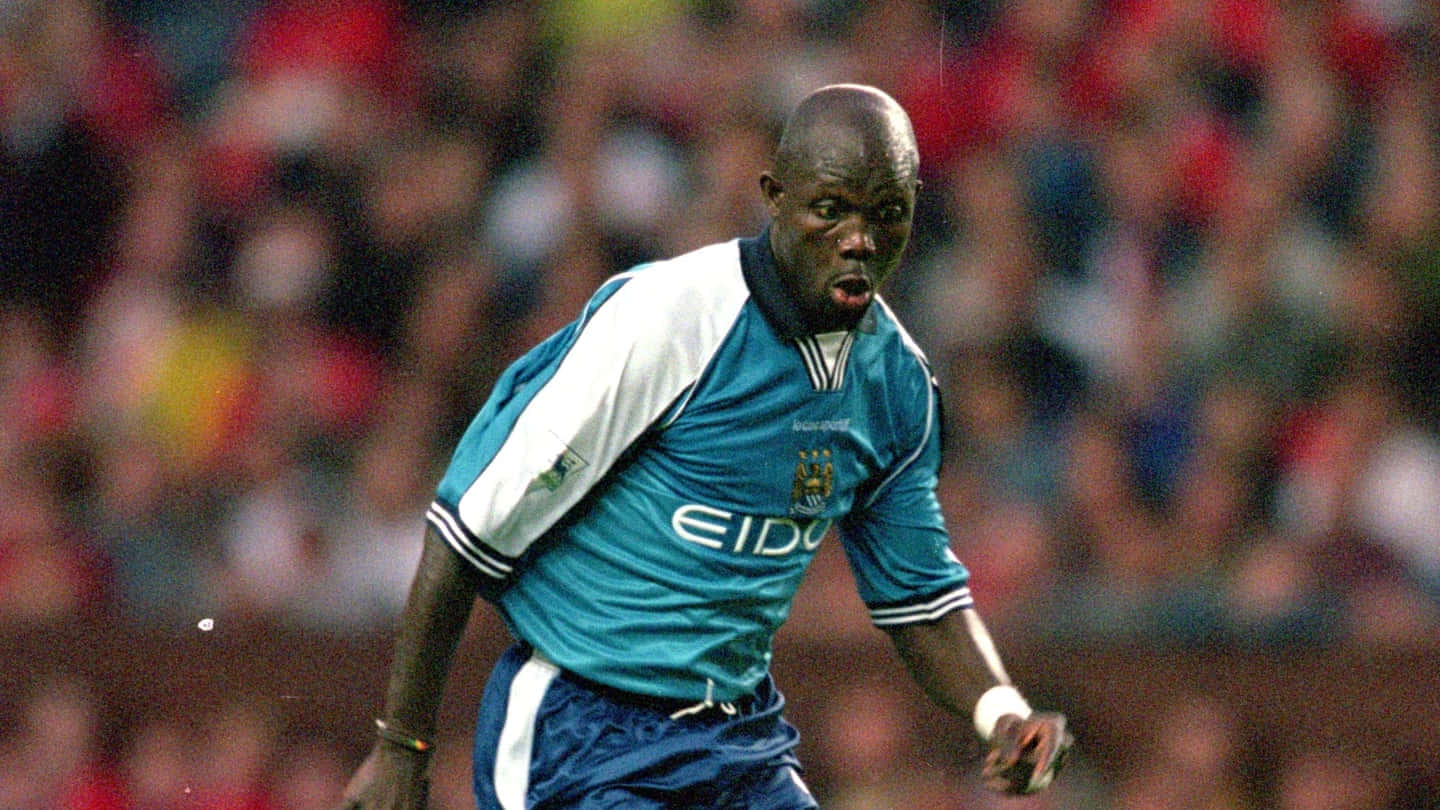 George Weah In Action At Maine Road Background