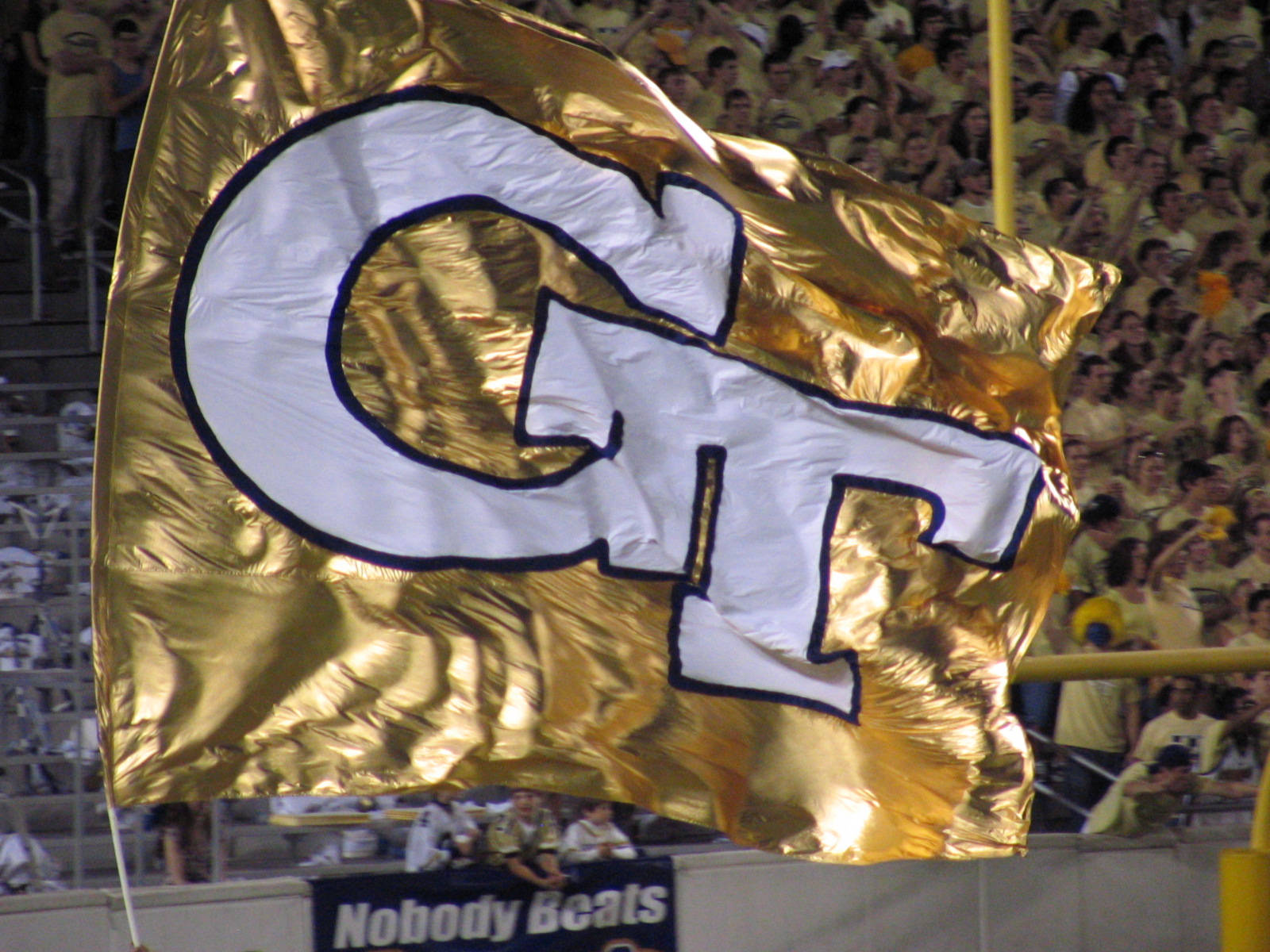 Georgia Tech Gold Banner Draping Elegantly Over The College Architecture Background