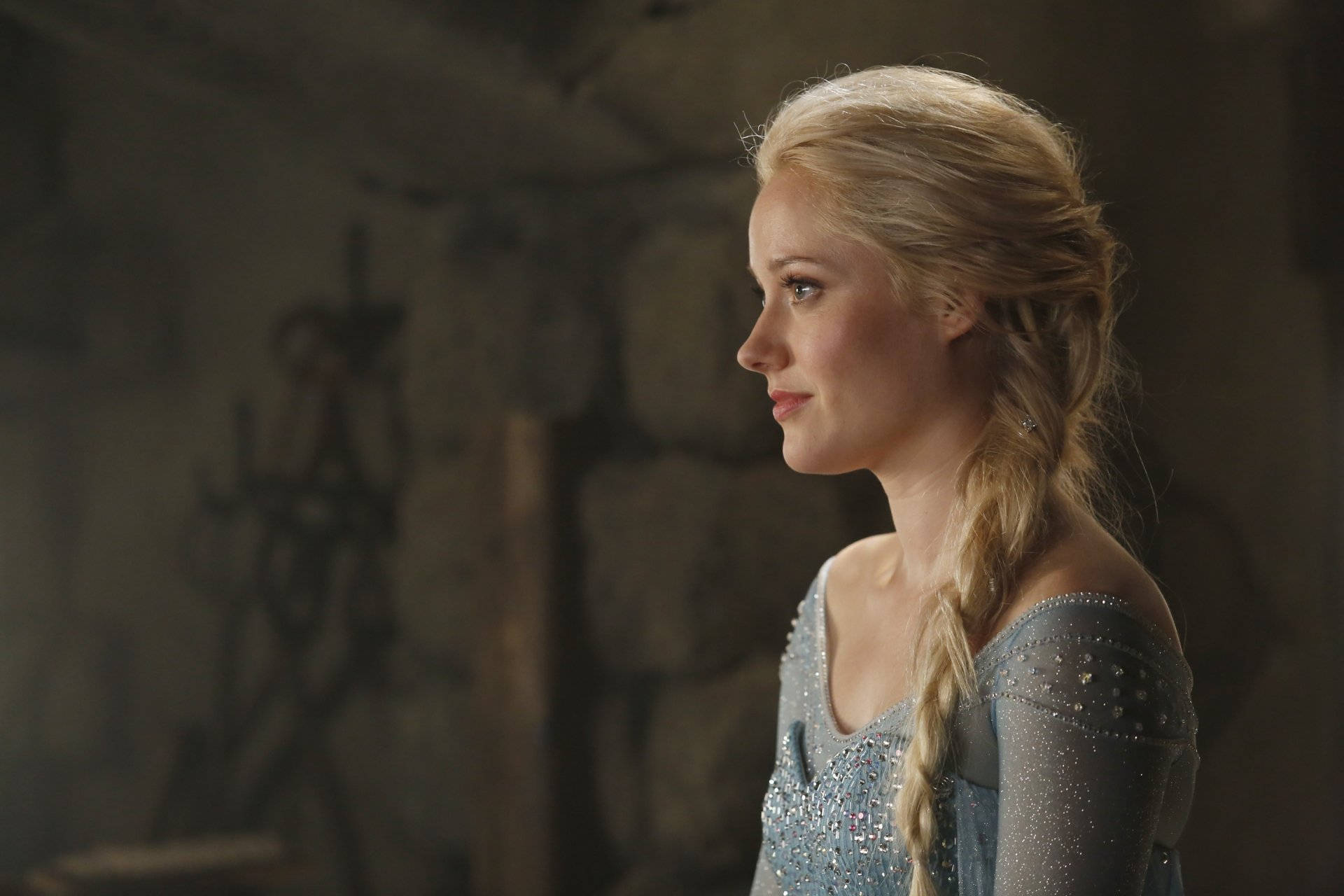 Georgina Haig Embodying The Character Of Elsa In A Stunning Icy Blue Ensemble Background