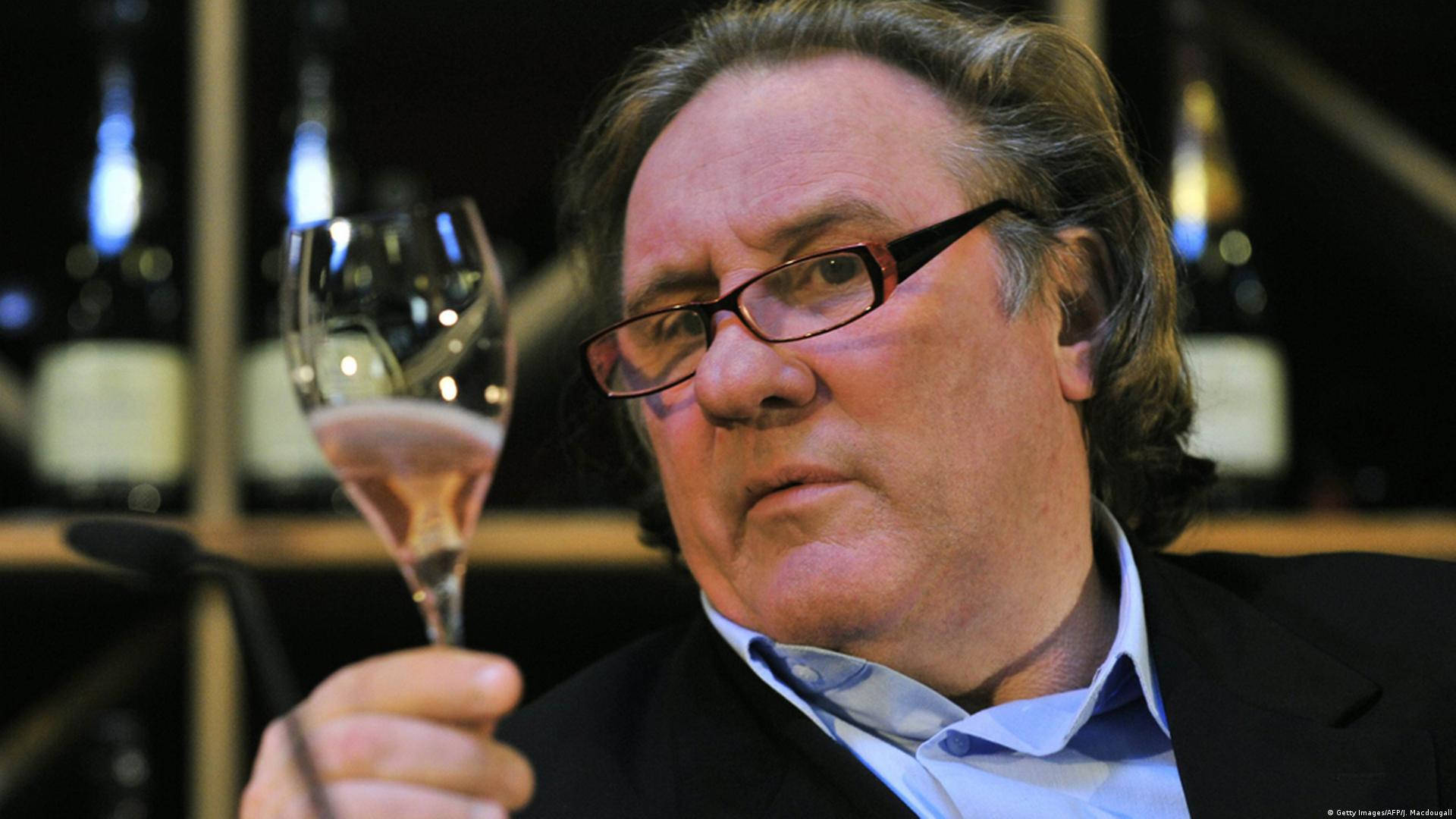 Gérard Depardieu Holding Champagne Glass