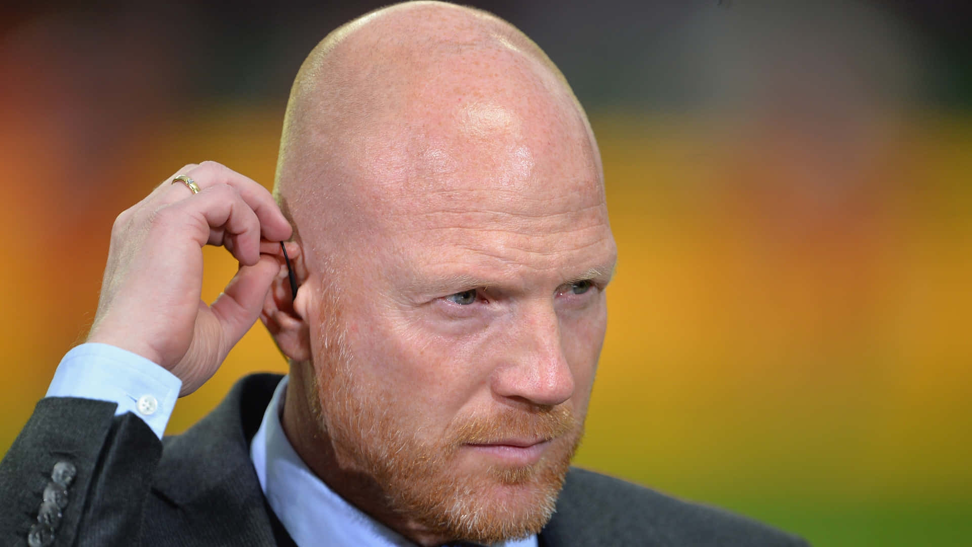 German Football Player Matthias Sammer Fixing His Earpiece Background