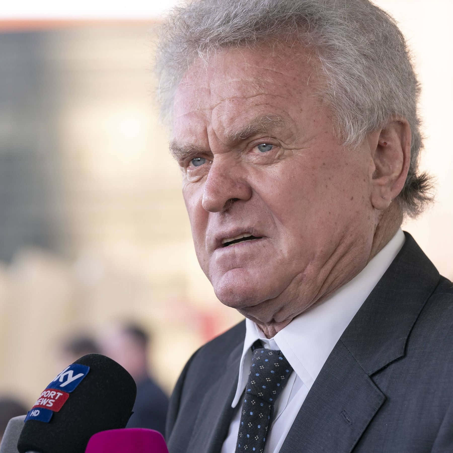 German Former Professional Football Goalkeeper Sepp Maier In A Suit Background
