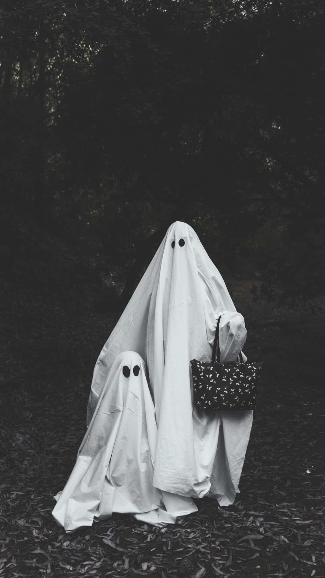 Ghostly Figuresin Forest Background