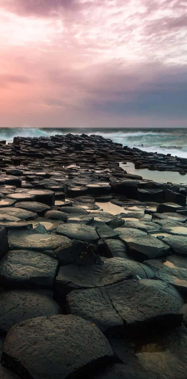 Giant's Causeway Pink Cloudy Sky Background