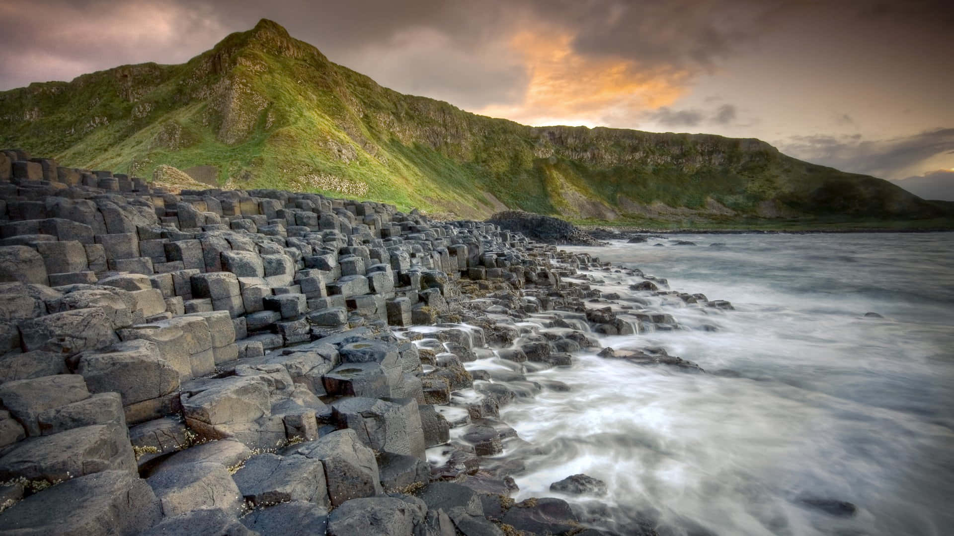 Giant's Causeway Rocks And Mountain Background